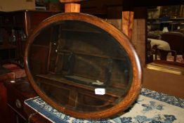 An oval dark-wood framed bevel edged Mirror, 28" x 18 1/2".