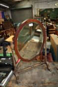 An oval bevel plated swing Mirror, 21'' wide x 27'' tall, a/f.