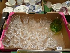A large quantity of cut glasses including 11 wine, whisky tumblers and a green glass jug etc.