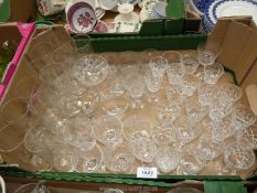 A large quantity of glasses including 5 etched with grapes and a quantity of tumblers.