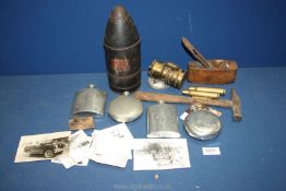 A quantity of miscellanea including a tin model of a shell used in 1914, four pewter hip flasks,