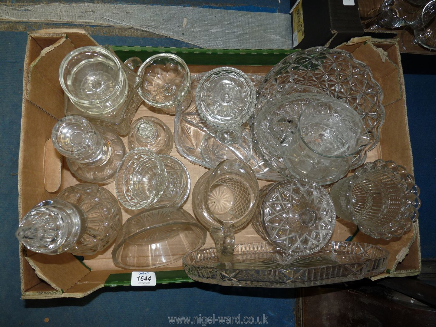 A large quantity of pressed glass items including a vase, two decanters, jugs, dessert dishes,