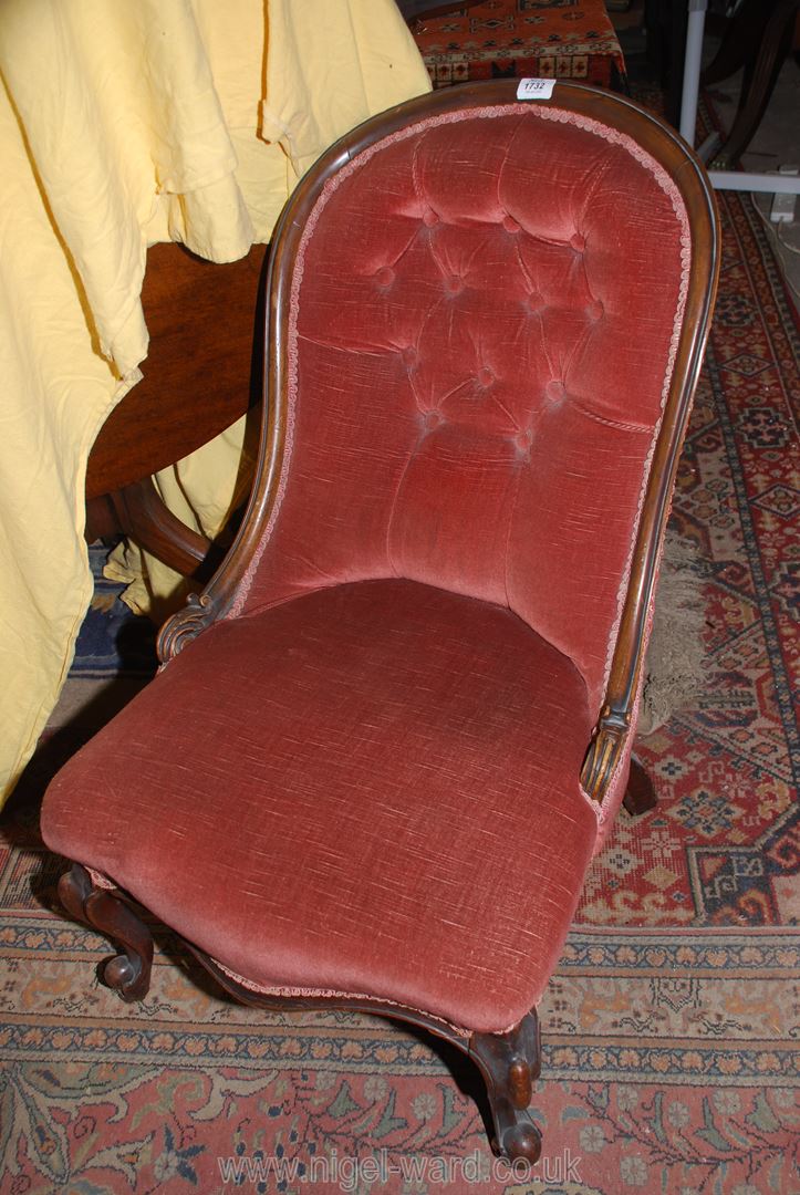 A Victorian Mahogany framed button back Chair upholstered in dusty pink Dralon and standing on