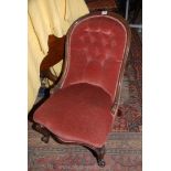 A Victorian Mahogany framed button back Chair upholstered in dusty pink Dralon and standing on