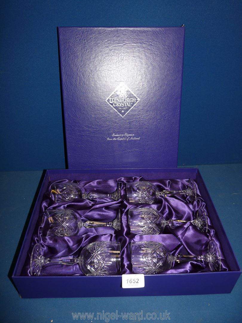 A boxed set of Edinburgh crystal white wine glasses.