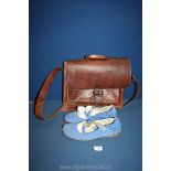 A pair of blue suede Chrio Moccasins and a leather satchel.