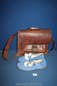 A pair of blue suede Chrio Moccasins and a leather satchel.