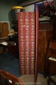 A large red floral fabric double folding Screen, 44" x 75 1/2" tall.