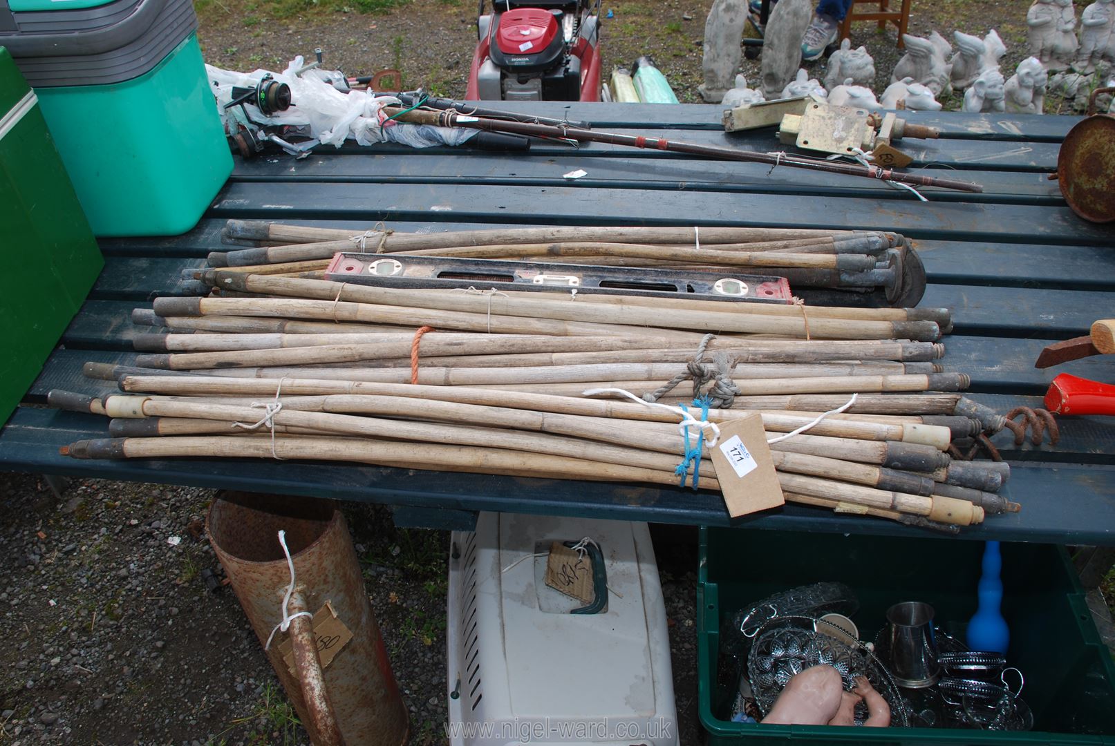 A quantity of drain rods and a spirit level.