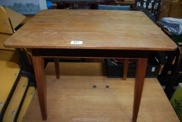 A plank top occasional table with tapered legs.