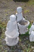 Two concrete children bird baths.