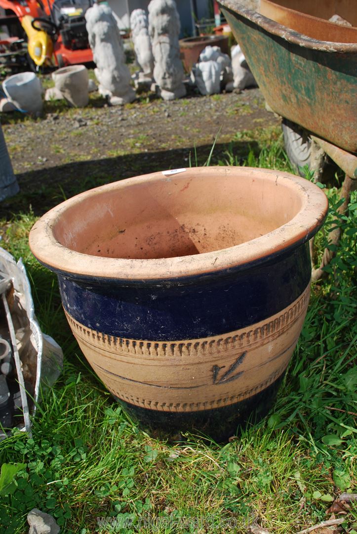 A large glazed terracotta planter.