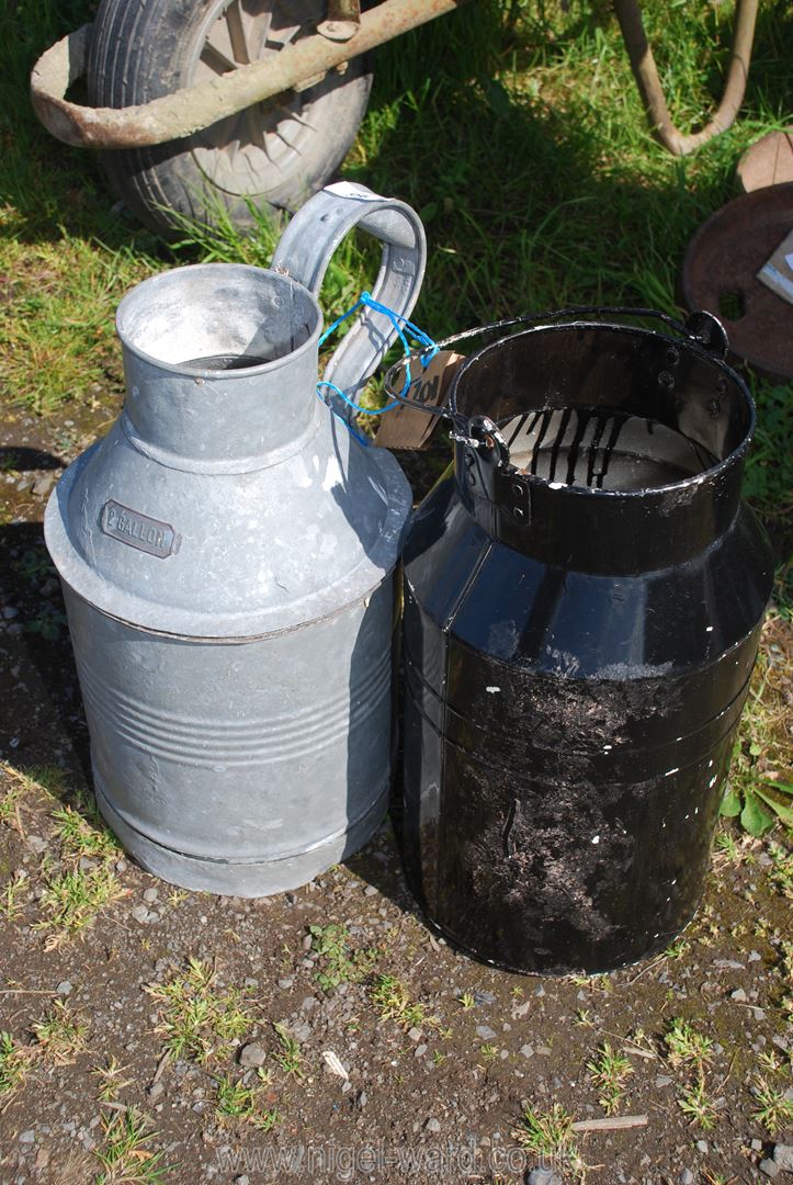 A black painted galvanised milk churn style planter and galvanised pitcher