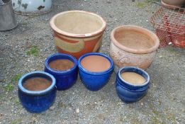 Two large planters, 13'' x 11 1/2'' and 13'' x 15'' and four small glazed pots.