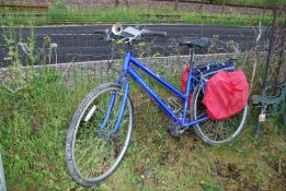 An Apollo step through 21 gears mountain bike with panniers.