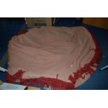 A heavy pink double thickness table cover with fringing