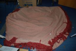 A heavy pink double thickness table cover with fringing