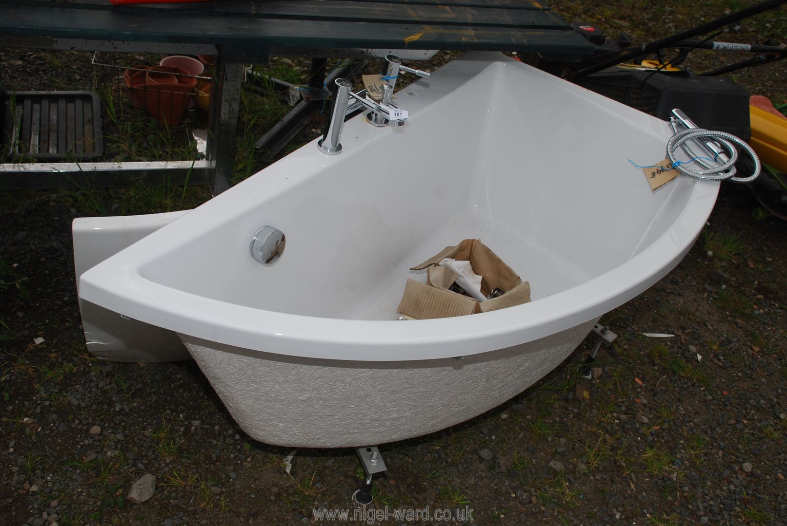 A Cersanit corner bath unit with taps, etc.