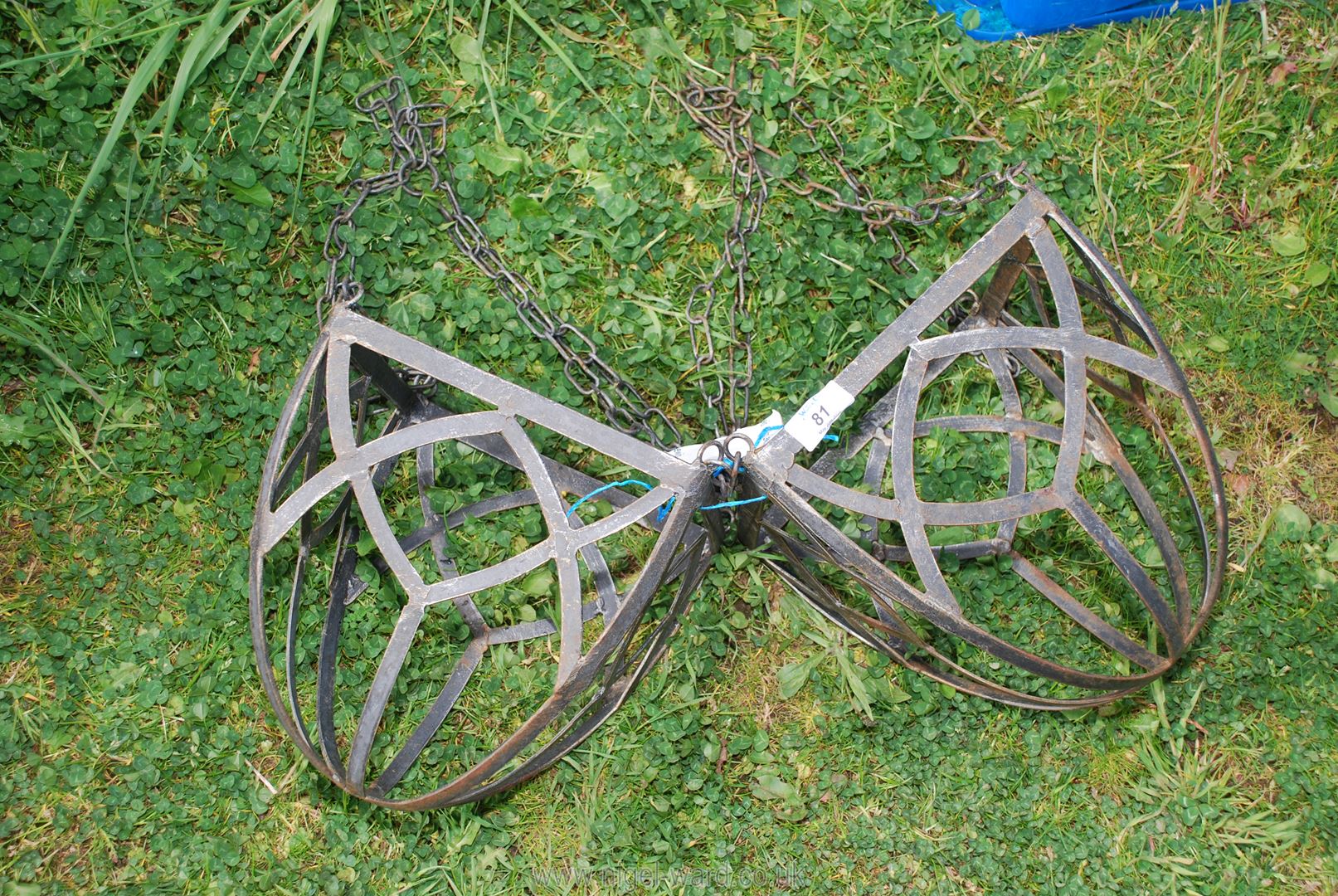 A pair of metal hanging baskets.