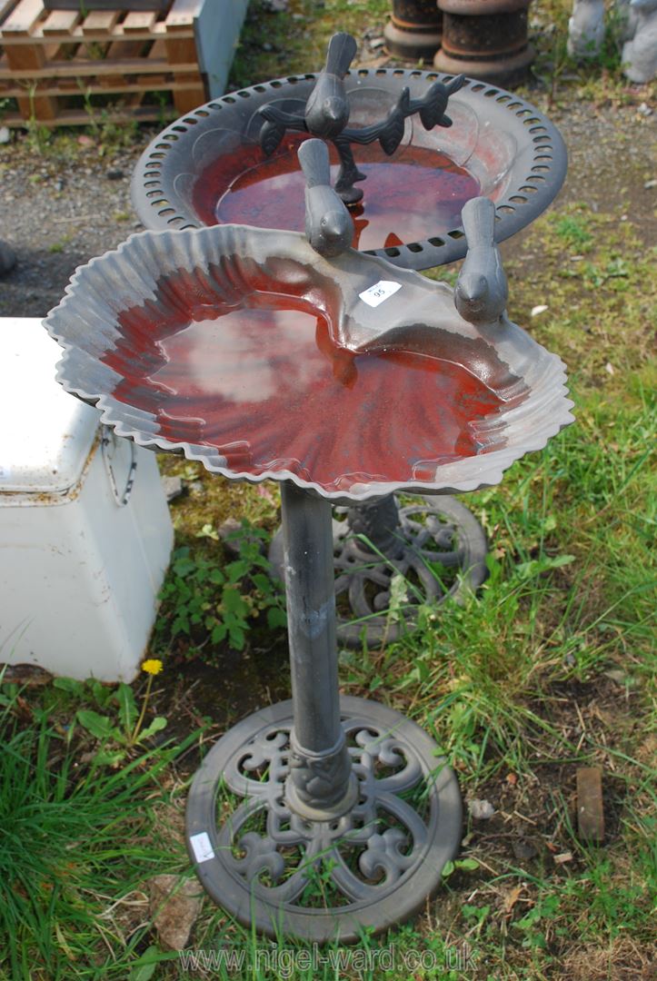 Two plastic bird baths.