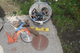 A bucket containing planes, rip saw blades, spirit level, small impact sockets, etc.