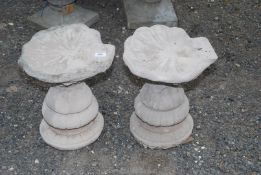 Two concrete bird baths.