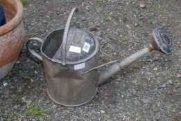 A galvanized watering can with rose sprinkler.