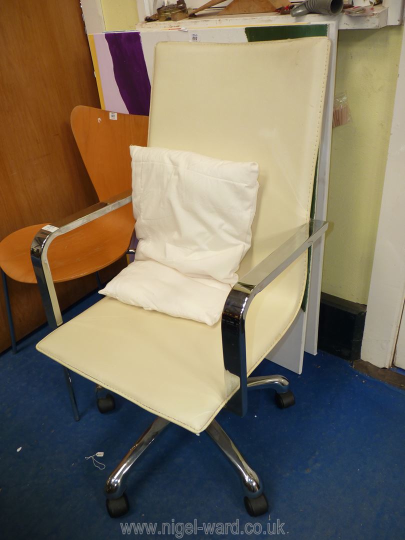 A chrome and cream faux leather office chair