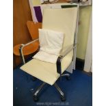 A chrome and cream faux leather office chair