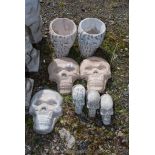 Two concrete skull planters and various skulls.