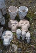 Two concrete skull planters and various skulls.