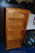 A narrow set of Pine shelves 49" tall.