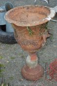 A large terracotta Urn with grape vine decorations (some chips).