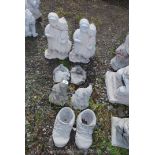 Eight concrete ornaments including two boots, two pixies, two courting couples and two birds.