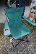 A collapsible canvas fishing chair in green.