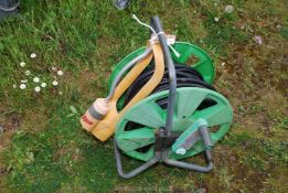 A large hose and reel and a water sprinkler.