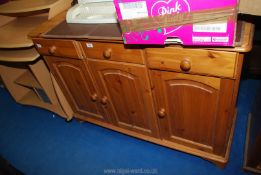 A Pine sideboard with 3 drawers over 3 cupboards 46" x 17" x 32 1/2" high.