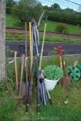 A large quantity of tools including axes, loppers, etc.