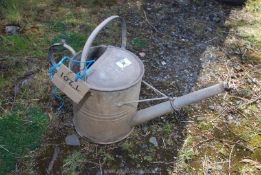 A galvanised watering can.
