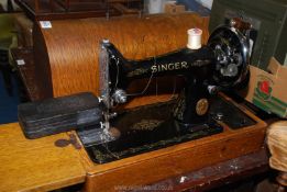 A Singer hand sewing machine with accessories