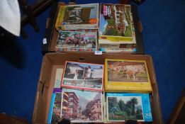 Two boxes of jigsaw puzzles.