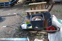 A wheelbarrow with pneumatic tyre and quantity of pots.