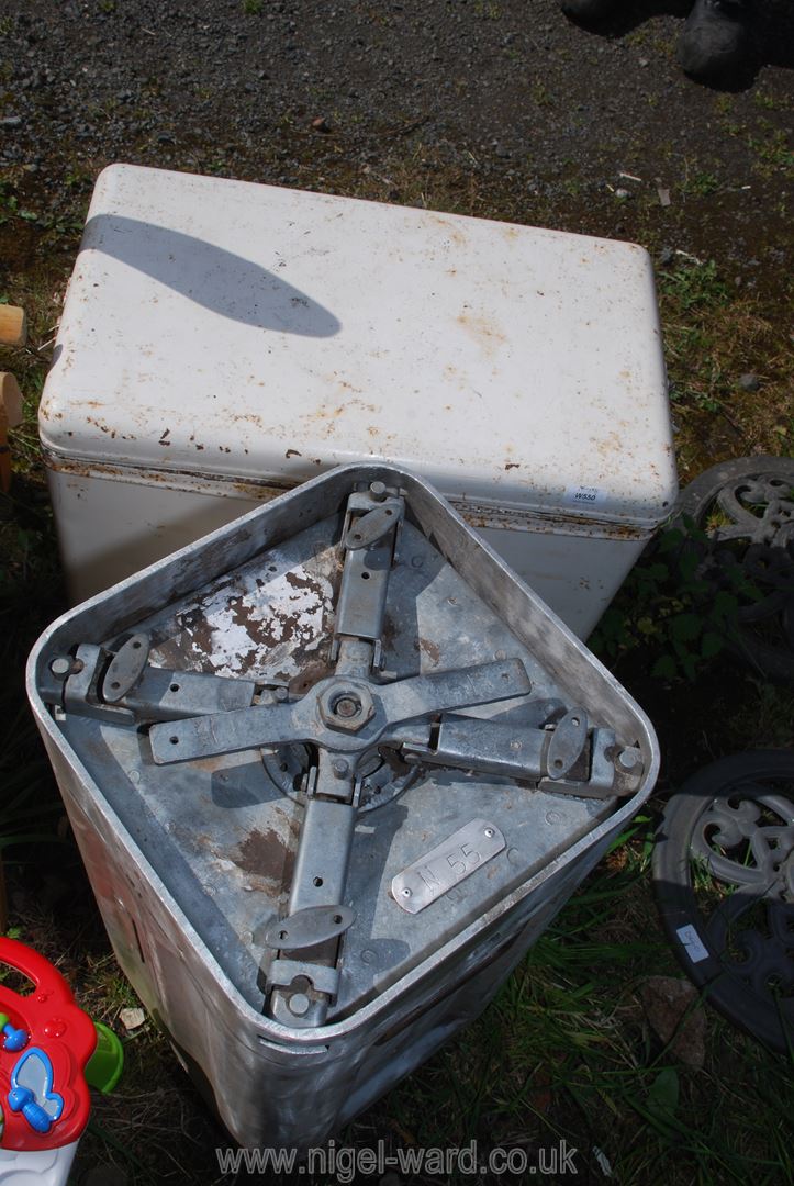 A metal cool box and aluminium canister.