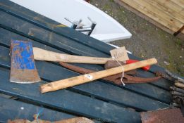 An axe, sledge hammer handle, lot splitter head and pick axe head.
