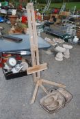 A trug, pair of wooden clogs and an easel.