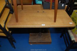 A small breakfast table on cast pedestal base having solid wood plinth.