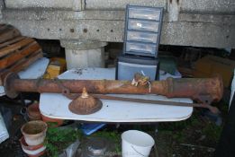 A vintage cast iron water pump handle with top cap present, 66" high.