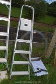 A five rung aluminium stepladder.