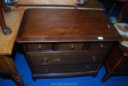 A Stag dressing table with triptych mirror and a matching chest of drawers.