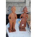Two cast iron fire companion holders in the form of Dutch figures.